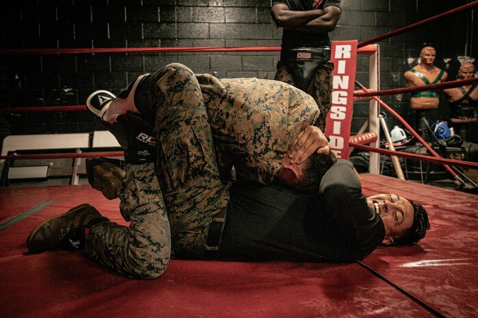 U.S. Marine Corps Martial Arts Instructor Trainer, Sgt. Sean Okeefe with Support Battalion, Recruit Training Regiment, Marine Corps Recruit Depot San Diego, challenges a Marine during the culminating event of a Marine Corps Martial Arts Instructor Course at MCRD San Diego, California, Dec. 18, 2024. After three weeks of training, MAI Course Class 19-24 conducted a five-hour culminating event that challenged students to show expertise in ground fighting, weapons-free sparring, and bayonet and knife techniques. (U.S. Marine Corps photo by Cpl. Sarah M. Grawcock)