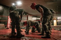 U.S. Marine Corps Martial Arts Instructor Trainers with Support Battalion, Recruit Training Regiment, Marine Corps Recruit Depot San Diego, challenge a Marine during the culminating event of a Marine Corps Martial Arts Instructor Course at MCRD San Diego, California, Dec. 18, 2024. After three weeks of training, MAI Course Class 19-24 conducted a five-hour culminating event that challenged students to show expertise in ground fighting, weapons-free sparring, and bayonet and knife techniques. (U.S. Marine Corps photo by Cpl. Sarah M. Grawcock)