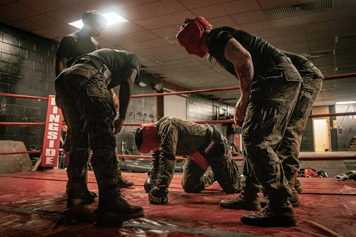 U.S. Marine Corps Martial Arts Instructor Trainers with Support Battalion, Recruit Training Regiment, Marine Corps Recruit Depot San Diego, challenge a Marine during the culminating event of a Marine Corps Martial Arts Instructor Course at MCRD San Diego, California, Dec. 18, 2024. After three weeks of training, MAI Course Class 19-24 conducted a five-hour culminating event that challenged students to show expertise in ground fighting, weapons-free sparring, and bayonet and knife techniques. (U.S. Marine Corps photo by Cpl. Sarah M. Grawcock)