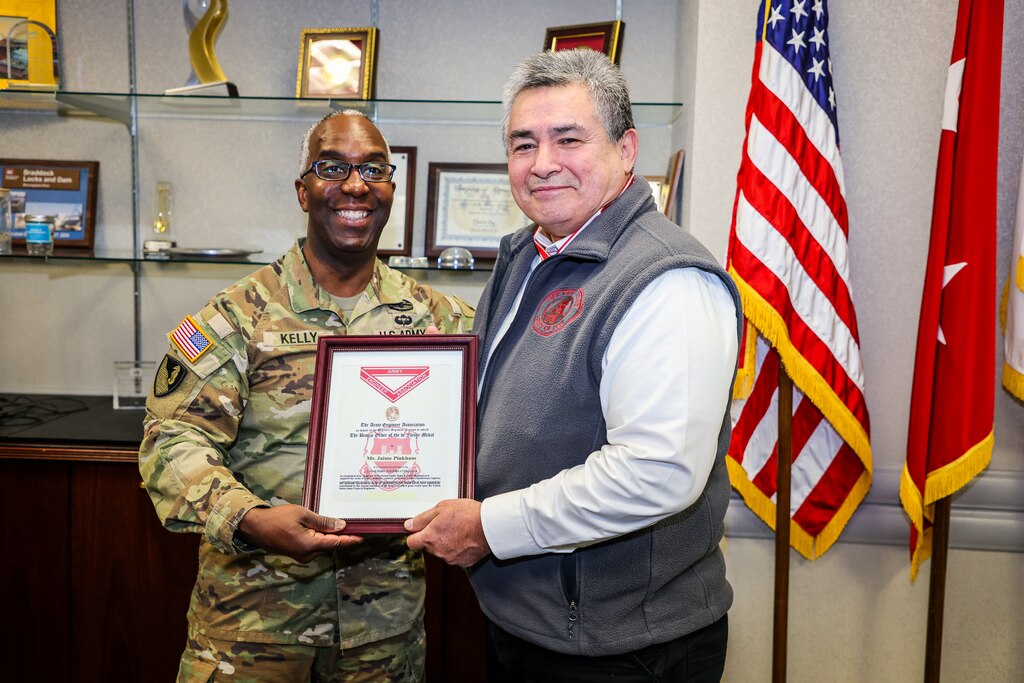 A Soldier presents a medal to a man