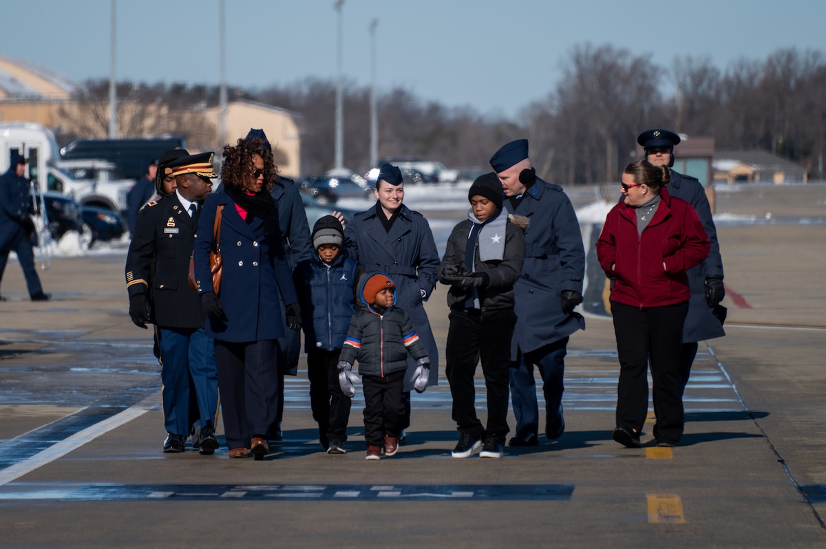 U.S. service members assigned within the National Capital Region, and family members, arrive on the flight line prior to the departure ceremony for the State Funeral of former President Jimmy Carter at Joint Base Andrews, Md., Jan. 9, 2025. Among Department of Defense leadership, approximately 200 military families across the NCR attended the departure ceremony to bid farewell to the former president. (U.S. Air Force photo by Staff Sgt. Alex Broome)