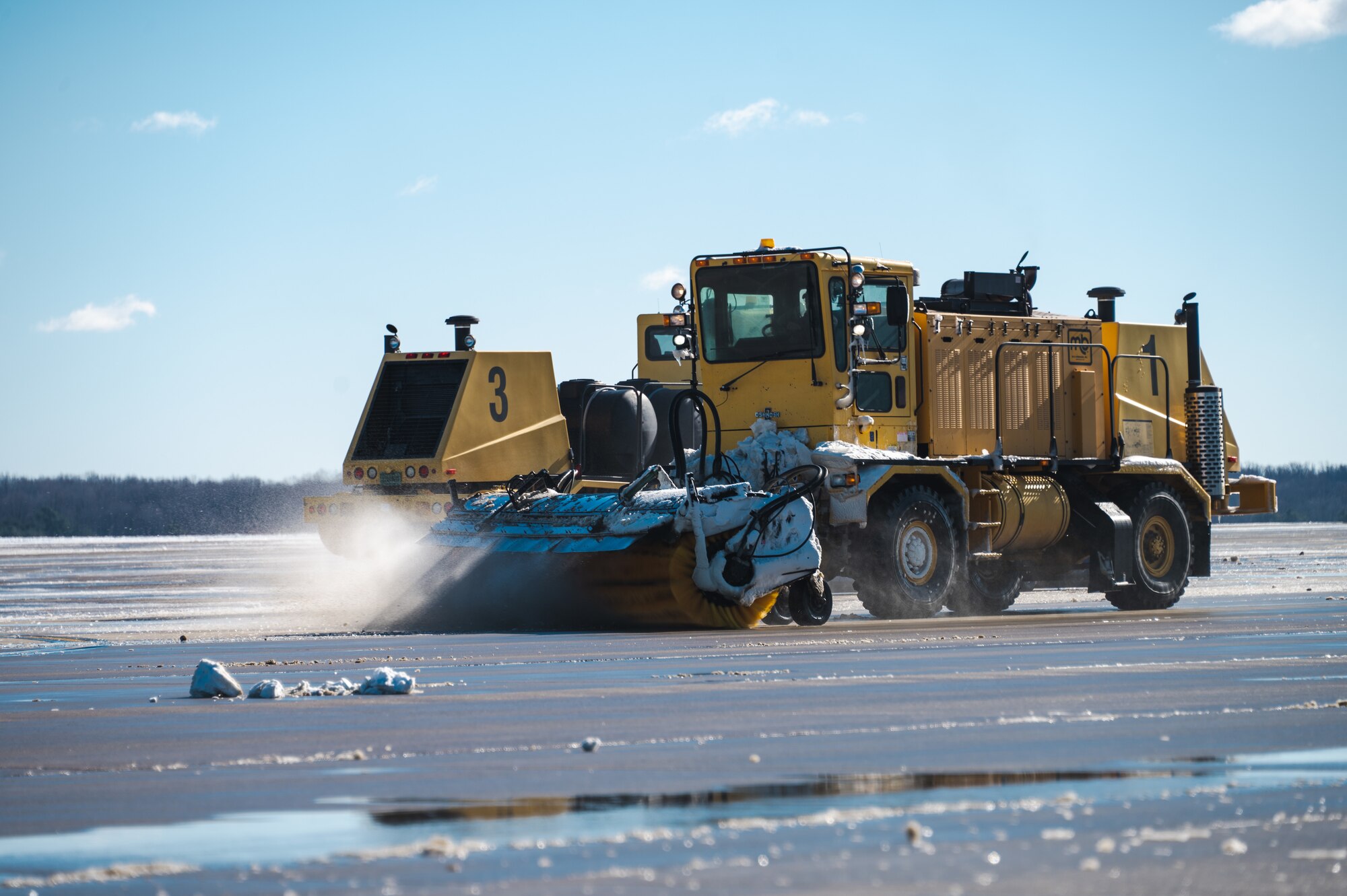 A snowplow from the 316th Civil Engineer Squadron clears the flight line at Joint Base Andrews, Md., Jan. 7, 2025. The removal was essential to prepare the flight line for the arrival of Special Air Mission 39, the VC-22 aircraft which transported former President Jimmy Carter, his family and friends during his state funeral. (U.S. Air Force photo by Staff Sgt. Alex Broome)