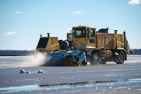 A snowplow from the 316th Civil Engineer Squadron clears the flight line at Joint Base Andrews, Md., Jan. 7, 2025. The removal was essential to prepare the flight line for the arrival of Special Air Mission 39, the VC-22 aircraft which transported former President Jimmy Carter, his family and friends during his state funeral. (U.S. Air Force photo by Staff Sgt. Alex Broome)