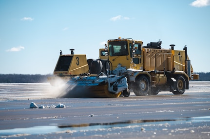 A snowplow from the 316th Civil Engineer Squadron clears the flight line at Joint Base Andrews, Md., Jan. 7, 2025. The removal was essential to prepare the flight line for the arrival of Special Air Mission 39, the VC-22 aircraft which transported former President Jimmy Carter, his family and friends during his state funeral. (U.S. Air Force photo by Staff Sgt. Alex Broome)