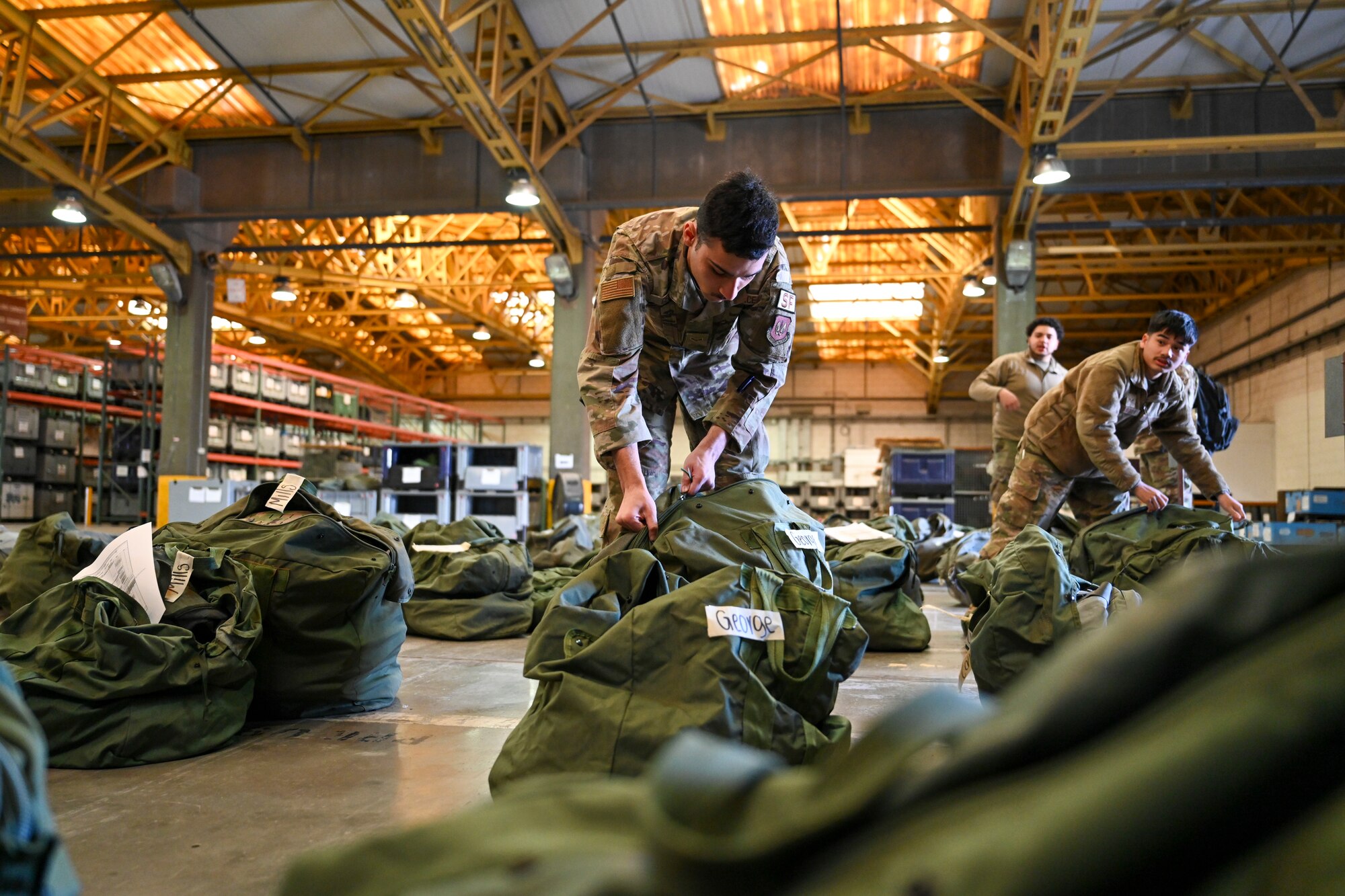 Senior Airman Thawatchai Duangkla, 39th Logistics Readiness Squadron Individual Protection Equipment journeyman, prepares initial issue bags to new members assigned to Incirlik Air Base, Türkiye, Dec. 19, 2024. The IPE team plays a crucial role in maintaining and distributing essential gear, ensuring Airmen are equipped for both training exercises and real-world threats that support NATO’s mission. (U.S. Air Force photo by Staff Sgt. Joshua Hoskins)