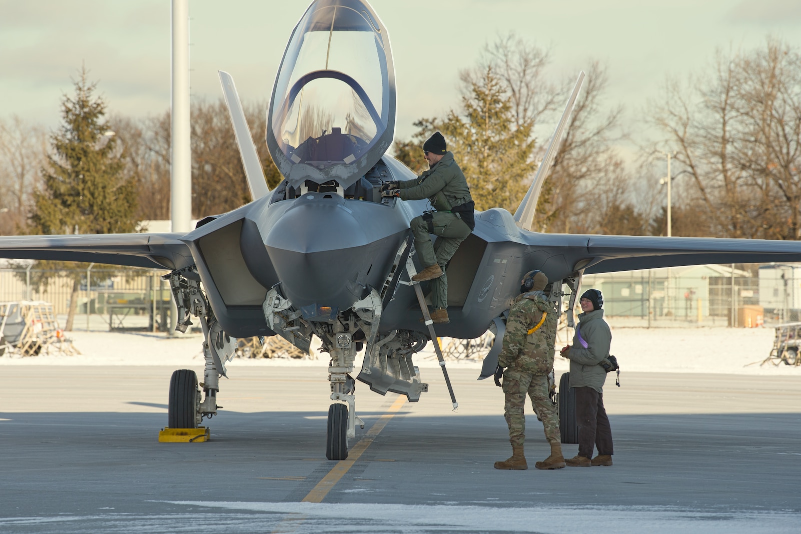 A photo of a fighter pilot assigned to the 158th Fighter Wing prepares climbs into the cockpit of an F-35A Lightning II aircraft at the Vermont Air National Guard Base, South Burlington, Vermont, Jan. 6, 2025.