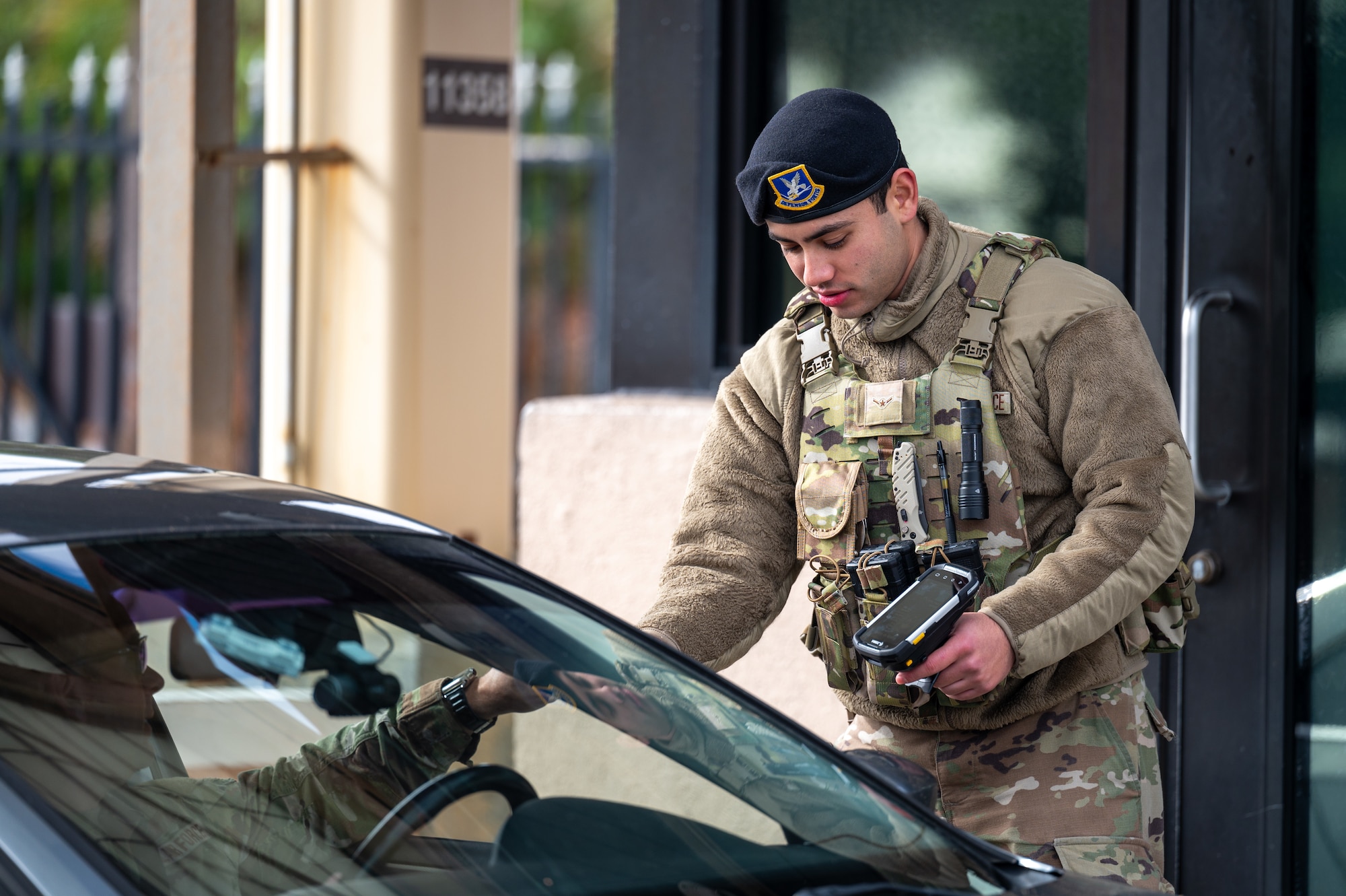 U.S. Air Force Airman Ian Aguiar, 45th Security Forces Squadron defender, scans a common access card at South Patrick Gate at Patrick Space Force Base, Florida, Jan. 7, 2025. Defenders perform checks at all entry control points on bases to ensure security and safety. (U.S. Space Force photo by Senior Airman Samuel Becker)