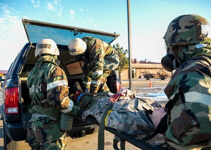 Airmen from the 138th Medical Group transport an injured Airmen into a simulated ambulance during a base wide exercise at Tulsa Air National Guard Base, Okla., Jan. 12, 2025. During the exercise, the Airmen were evaluated on their ability to maintain mission operations while operating in a simulated deployed environment, performed duties such as post-attack reconnaissance (PAR) team routes, simulated attacks, and tactical combat casualty care procedures. (Oklahoma Air National Guard photo by Senior Airman Addison Barnes)