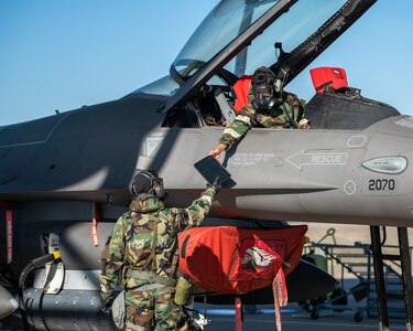 138th Aircraft Maintenance Squadron crew chiefs inspect a F-16 Viper during a base wide exercise at Tulsa Air National Guard Base, Okla., Jan. 12, 2025. During the exercise, the Airmen were evaluated on their ability to maintain mission operations while operating in a simulated deployed environment, performed duties such as post-attack reconnaissance (PAR) team routes, simulated attacks, and tactical combat casualty care procedures. (Oklahoma Air National Guard photo by Senior Airman Addison Barnes)