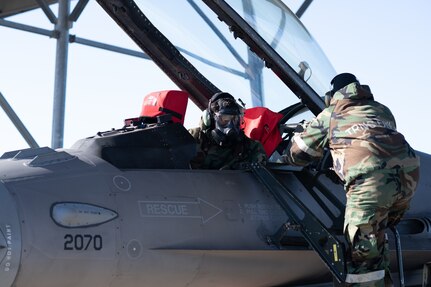 138th Aircraft Maintenance Squadron crew chiefs inspect a F-16 Viper upon return from flight during a base-wide exercise at Tulsa Air National Guard Base, Okla., Jan. 12, 2025. As a way to evaluate mission readiness, Airmen across base performed job duties while wearing Mission Oriented Protective Posture gear and responded to simulated emergencies. (Oklahoma Air National Guard photo by Staff Sgt. Jalen Rideaux)