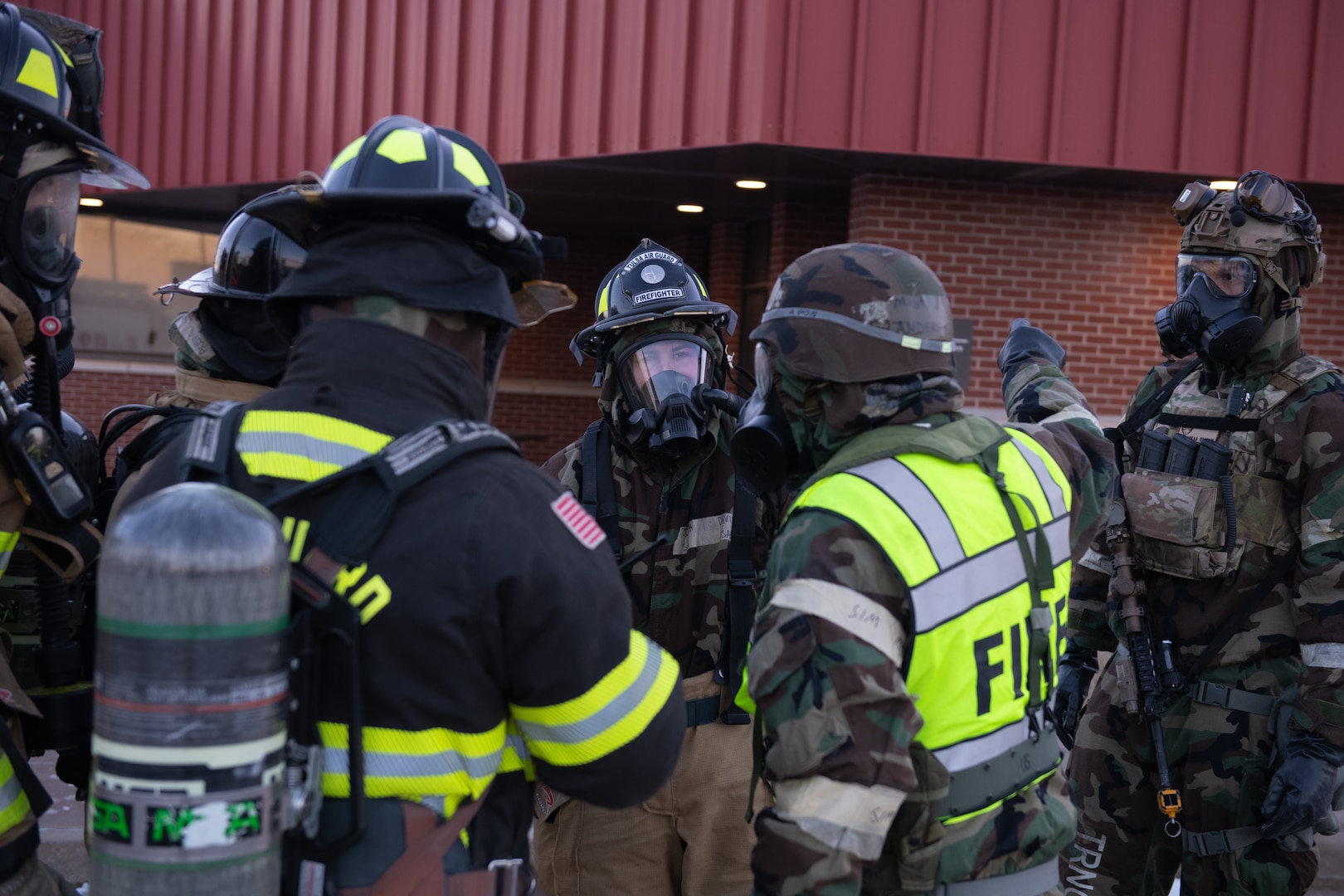 Members of the 138th Civil Engineering Squadron and 138th Security Forces Squadron, gather to plan next steps in response to a simulated emergency during a base-wide exercise at Tulsa Air National Guard Base, Okla., Jan. 12, 2025. The 138th CES and 138th SFS participated in a simulated contested environment as a part of a base-wide exercise aimed to maintain member readiness and evaluated response capabilities. (Oklahoma Air National Guard photo by Staff Sgt. Jalen Rideaux)