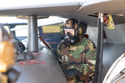 138th Maintenance Group Crew Chiefs completes his landing checklist on F-16 Viper upon return from flight during a base-wide exercise at Tulsa Air National Guard Base, Okla., Jan. 12, 2025. As a way to evaluate mission readiness, Airmen across base performed job duties while wearing Mission Oriented Protective Posture gear and responded to simulated emergencies. (Oklahoma Air National Guard photo by Staff Sgt. Jalen Rideaux)