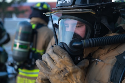 138th Civil Engineering Squadron Firefighter communicates via radio while engaging in the base-wide exercise at Tulsa Air National Guard Base, Okla., Jan. 12, 2025. The 138th CES were tasked with an emergency response to a simulated explosion, where they had to clear the building and provide life saving measures. (Oklahoma Air National Guard photo by Staff Sgt. Jalen Rideaux)