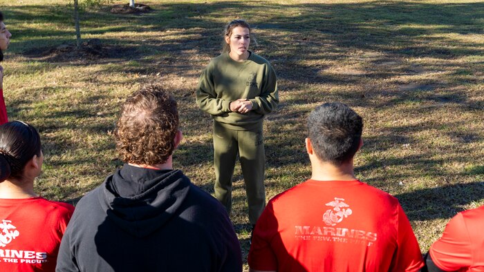 U.S. Marine Corps Gunnery Sgt. Elizabeth Rangel, the Military Entrance Processing Station chief with Recruiting Station Houston, 8th Marine Corps District, speaks to poolees after a poolee function with Marines at Gene Green Dog Park in Houston, Texas, Jan. 11, 2025. The poolees competed in teams throughout the day conducting pull-ups, a relay race, a simulated-resupply run, and a tug-of-war. (U.S. Marine Corps photo by Sgt. Ryan H. Pulliam)