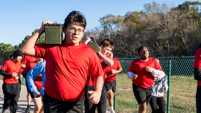 U.S. Marine Corps poolees with Recruiting Station Houston, 8th Marine Corps District, conduct a simulated-resupply run during a poolee function with Marines at Gene Green Dog Park in Houston, Texas, Jan. 11, 2025. The poolees competed in teams throughout the day conducting pull-ups, a relay race, a simulated-resupply run, and a tug-of-war. (U.S. Marine Corps photo by Sgt. Ryan H. Pulliam)