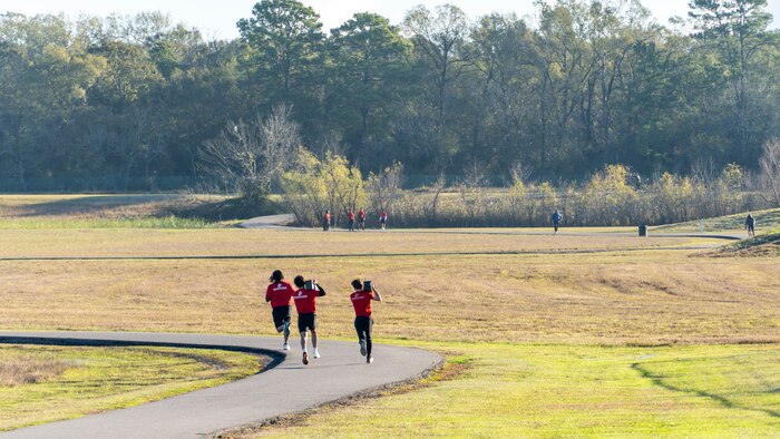 U.S. Marine Corps poolees with Recruiting Station Houston, 8th Marine Corps District, conduct a relay race during a poolee function with Marines at Gene Green Dog Park in Houston, Texas, Jan. 11, 2025. The poolees competed in teams throughout the day conducting pull-ups, a relay race, a simulated-resupply run, and a tug-of-war. (U.S. Marine Corps photo by Sgt. Ryan H. Pulliam)