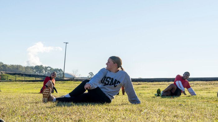 U.S. Marine Corps poolees with Recruiting Station Houston, 8th Marine Corps District, conduct cool-down exercises during a poolee function with Marines at Gene Green Dog Park in Houston, Texas, Jan. 11, 2025. The poolees competed in teams throughout the day conducting pull-ups, a relay race, a simulated-resupply run, and a tug-of-war. (U.S. Marine Corps photo by Sgt. Ryan H. Pulliam)