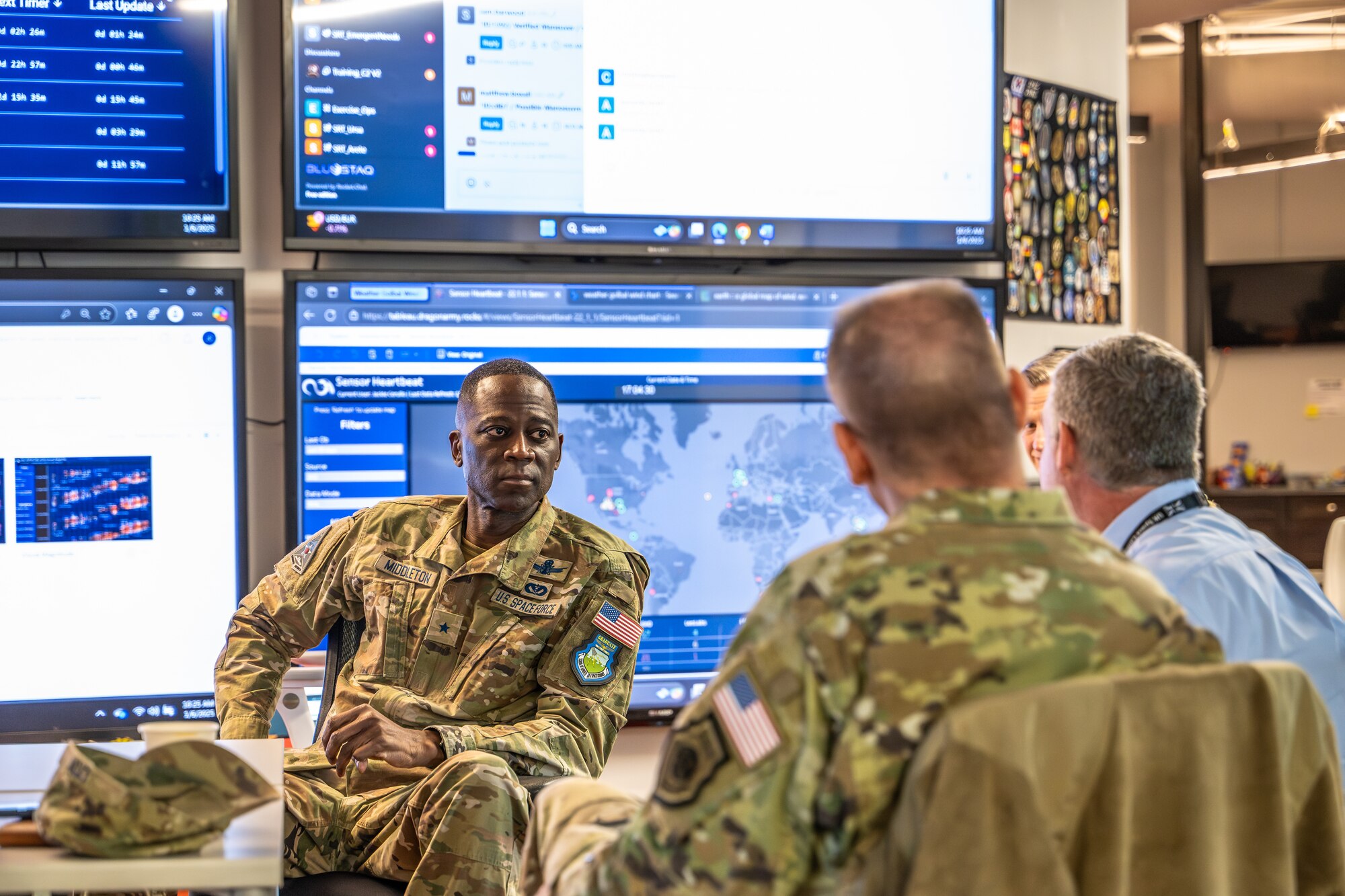Man in uniform listens to briefing