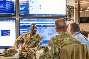 Man in uniform listens to briefing