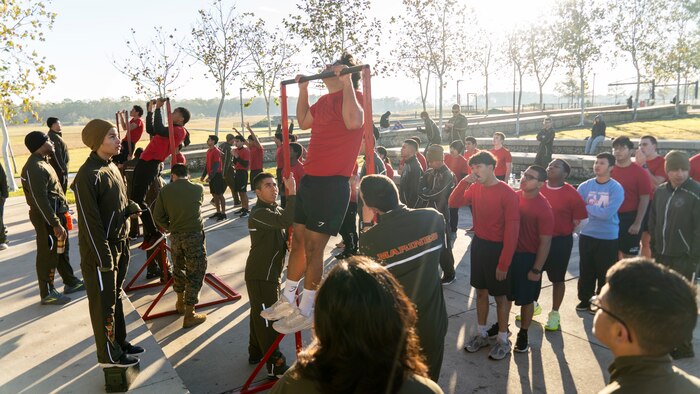 U.S. Marine Corps poolees with Recruiting Station Houston, 8th Marine Corps District, conduct a pull-up competition during a poolee function with Marines at Gene Green Dog Park in Houston, Texas, Jan. 11, 2025. The poolees competed in teams throughout the day conducting pull-ups, a relay race, a simulated-resupply run, and a tug-of-war. (U.S. Marine Corps photo by Sgt. Ryan H. Pulliam)