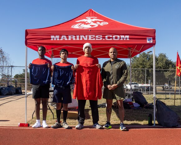U.S. Marine Corps Sgt. Maj. Steven C. Jackman , the command senior-enlisted leader of Recruiting Station Austin, poses for a picture with Poolees during a Initial Strength Test(IST) at Williamson County Regional Park in Leander, Texas, Jan. 11, 2025. The IST is a baseline-fitness test for the new recruits to ensure they meet the physical requirements to begin the 13-week transformation to earn the title United States Marine. (U.S. Marine Corps photo by Cpl. Jose D. Cruz)