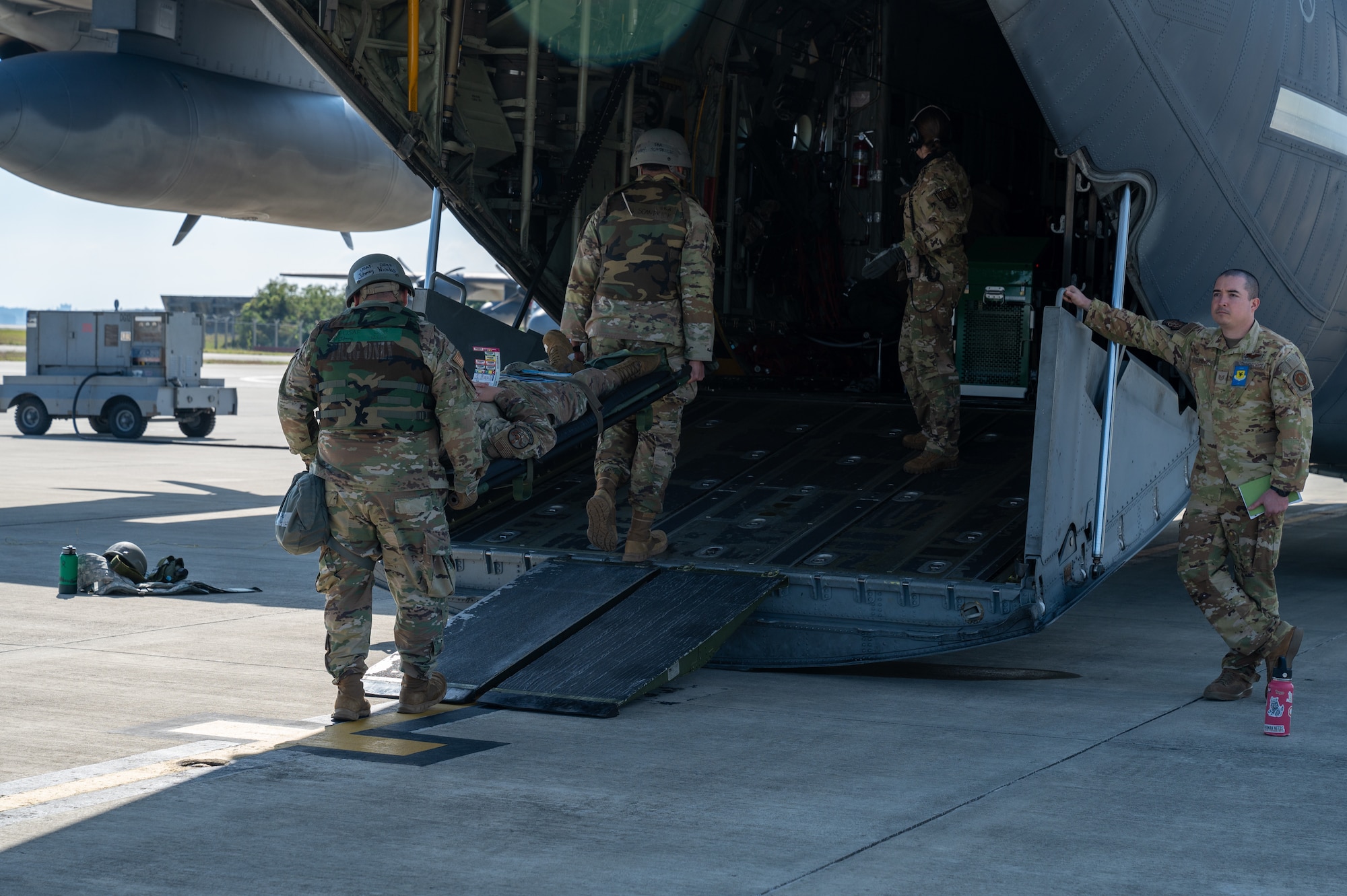 U.S. Air Force Airmen with the 18th Medical Group and the 18th Aeromedical Evacuation Squadron transfer a simulated patient during a mass casualty scenario during a routine readiness exercise at Kadena Air Base, Japan, Jan. 14, 2025.