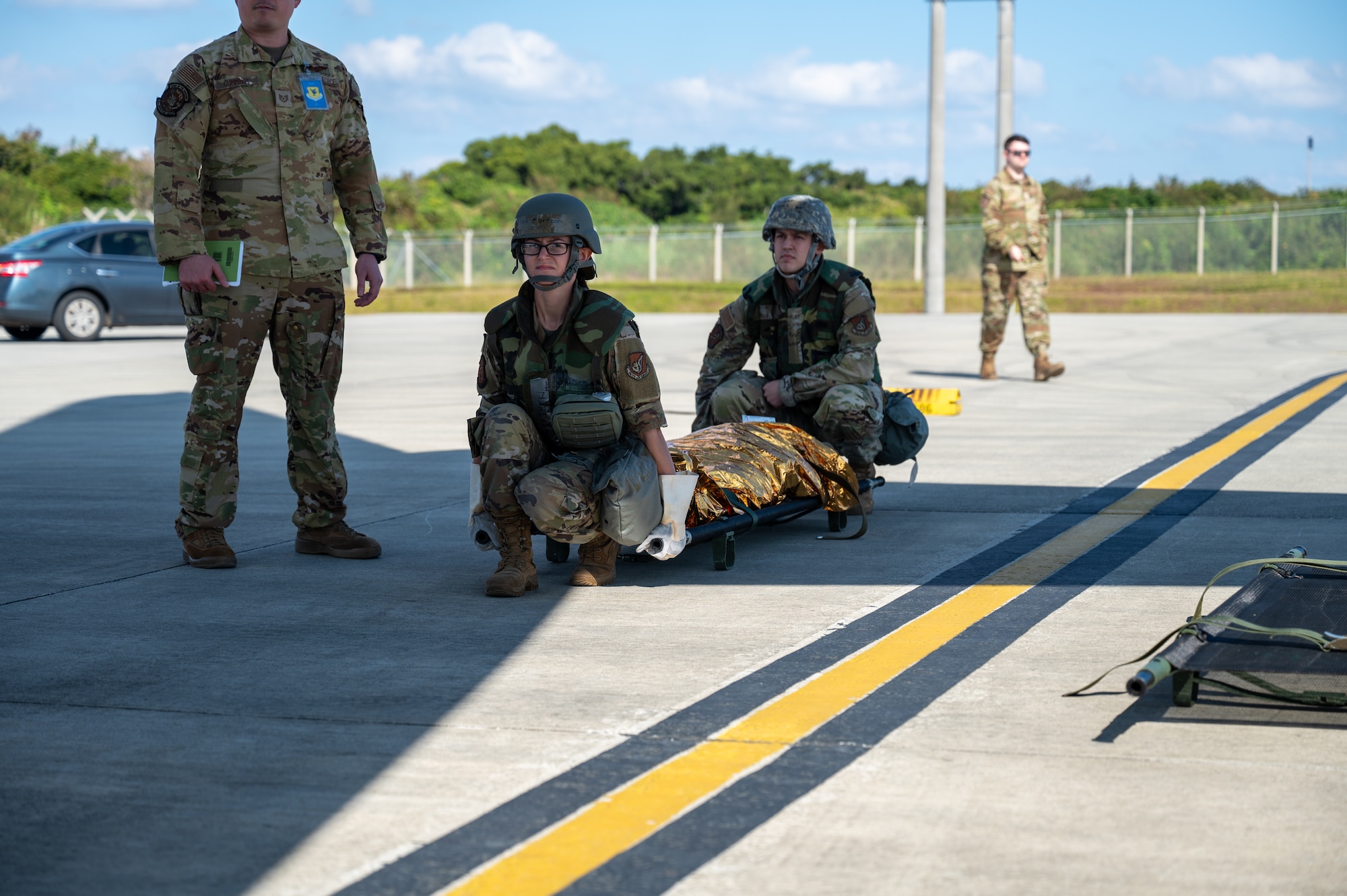 U.S. Air Force Airmen with the 18th Medical Group and the 18th Aeromedical Evacuation Squadron transfer a simulated patient during a mass casualty scenario during a routine readiness exercise at Kadena Air Base, Japan, Jan. 14, 2025.