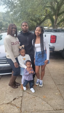 Army Recruiter poses with his family off-duty.