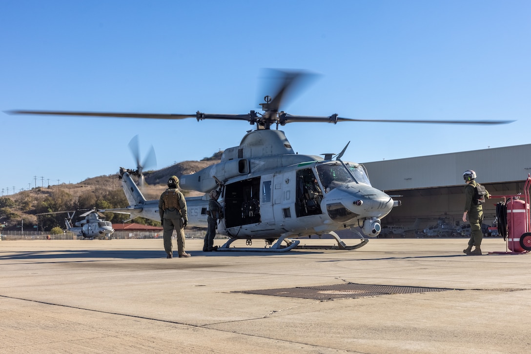 U.S. Marines with Marine Light Attack Helicopter Squadron (HMLA) 367, Marine Aircraft Group 39, 3rd Marine Aircraft Wing, conducts aircraft checks on a UH-1Y Venom at Marine Corps Air Station Camp Pendleton, California, Jan. 10, 2025. I Marine Expeditionary Force is posturing to provide a task-organized force of approximately 500 Marines with route clearance, commodity distribution, search and rescue, rotary-wing airlift, and general support capabilities if requested to respond to the wildfires in Southern California.  As Marines, we remain ready and prepared to provide assistance if called upon to serve our community and nation. (U.S. Marine Corps photo by Lance Cpl. Jennifer Sanchez)