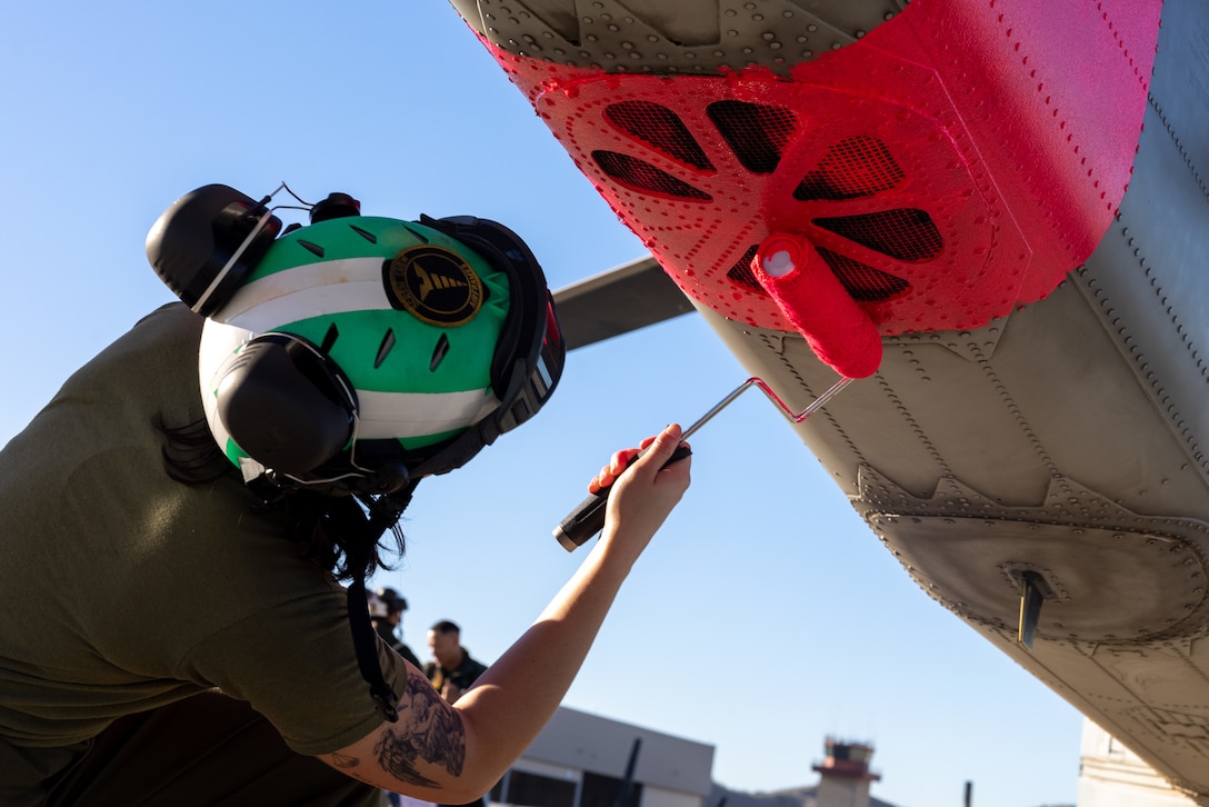 U.S. Marine Corps Cpl. Sofia Ferraiuolo, a helicopter airframe mechanic with Marine Light Attack Helicopter Squadron (HMLA) 367, Marine Aircraft Group 39, 3rd Marine Aircraft Wing, paints a UH-1Y Venom at Marine Corps Air Station Camp Pendleton, California, Jan. 10, 2025. I Marine Expeditionary Force is posturing to provide a task-organized force of approximately 500 Marines with route clearance, commodity distribution, search and rescue, rotary-wing airlift, and general support capabilities if requested to respond to the wildfires in Southern California.  As Marines, we remain ready and prepared to provide assistance if called upon to serve our community and nation. (U.S. Marine Corps photo by Lance Cpl. Jennifer Sanchez)