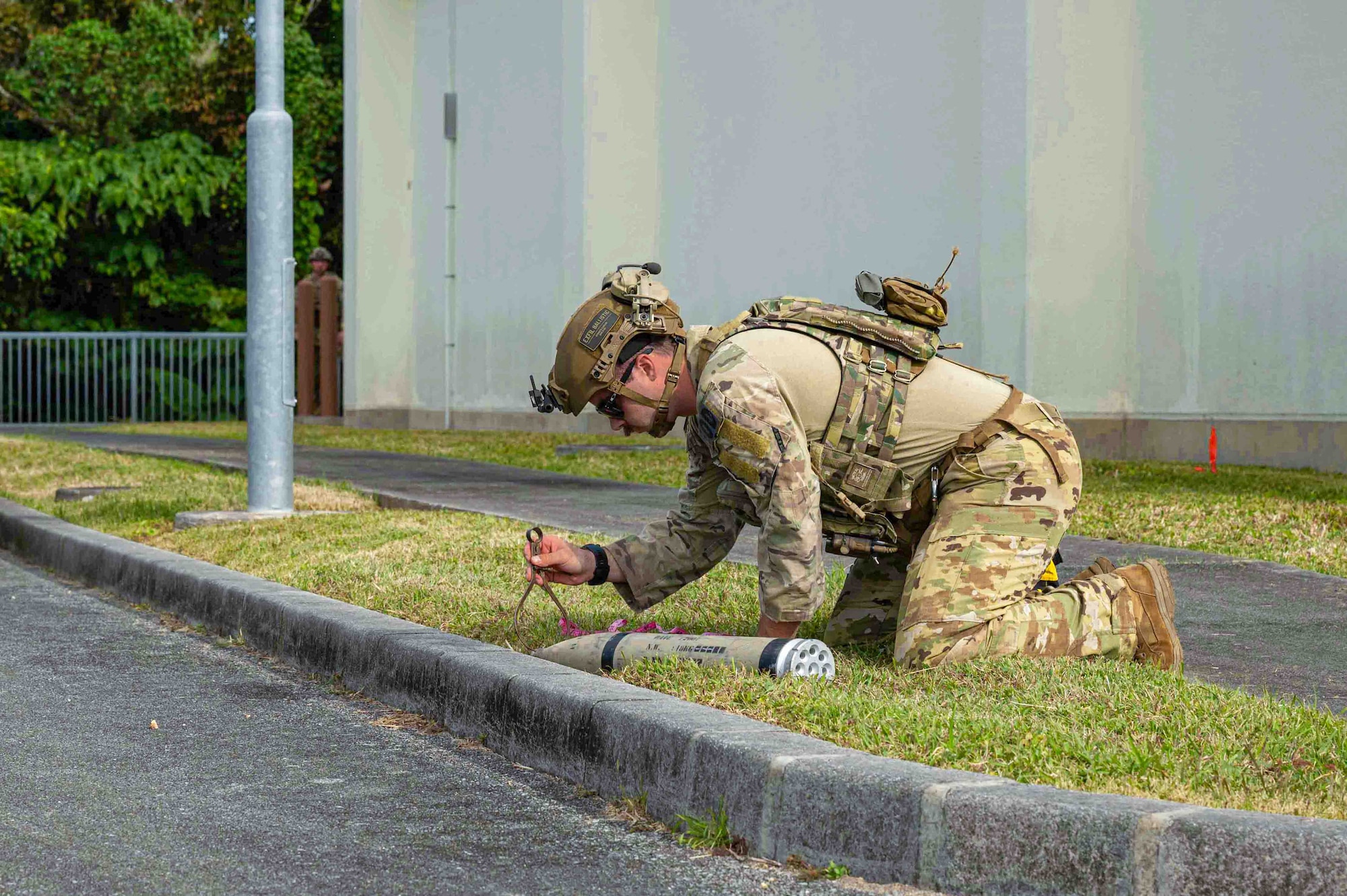 U.S. Air Force Senior Airman Gio Varano, Explosive Ordnance Disposal technician with the 18th Civil Engineer Squadron, conducts a removal of a simulated unexploded ordnance during a routine readiness exercise at Kadena Air Base, Japan, Jan. 14, 2025.
