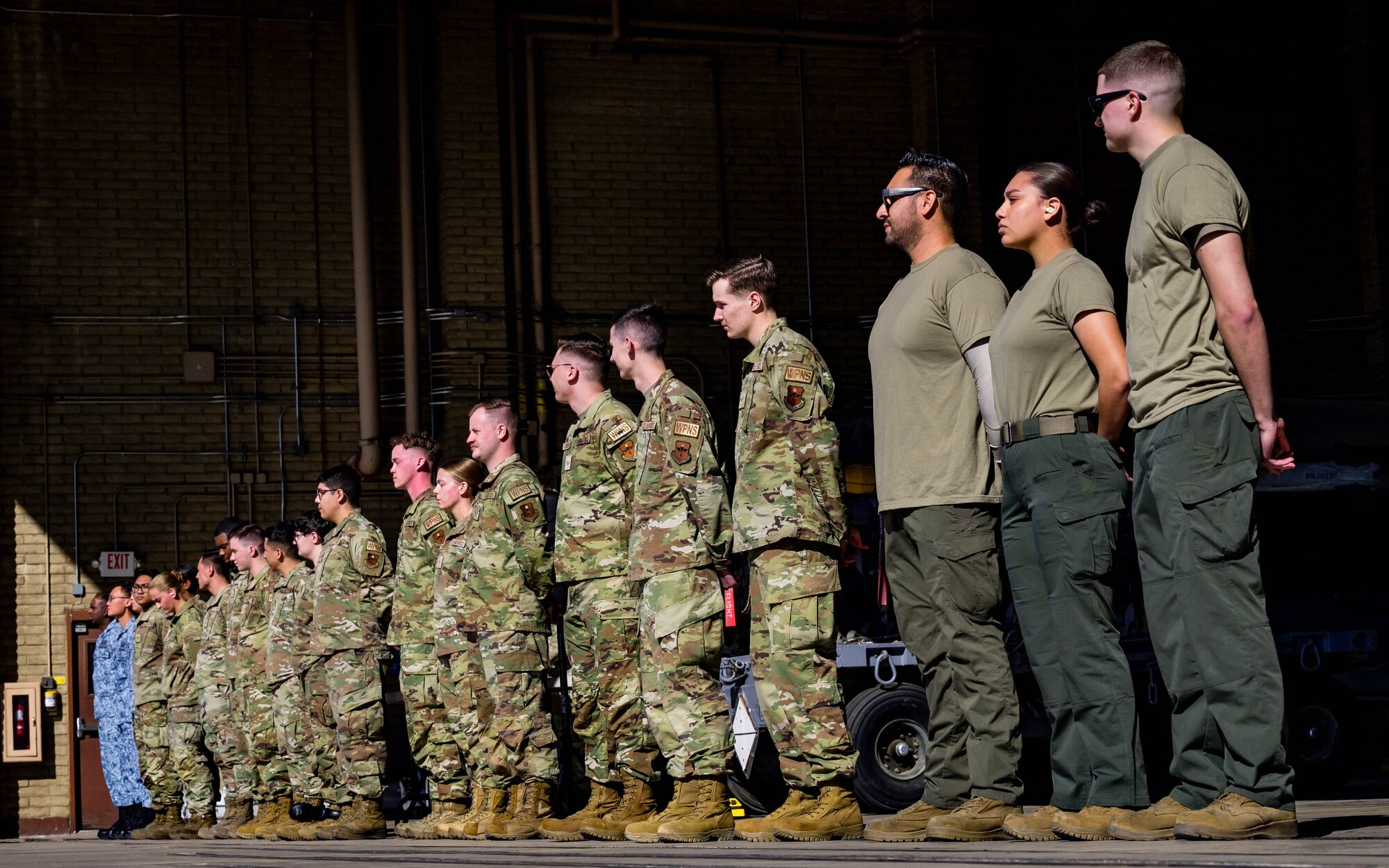 U.S. Air Force Airmen assigned to the 56th Fighter Wing and Republic of Singapore Air Force members are introduced before beginning the First Quarter Weapons Load Competition.