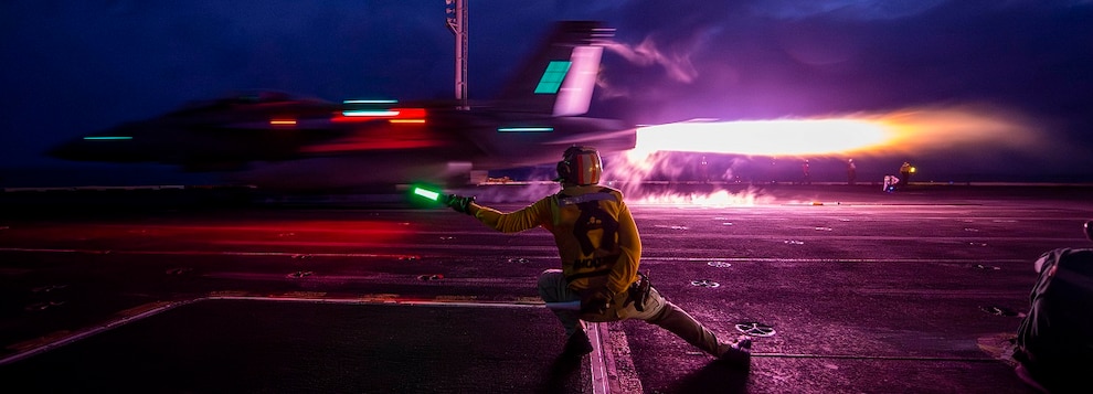 Lt. Clint Vance, of Kalispell, Mont., signals an  F/A-18F Super Hornet assigned to the “Bounty Hunters” of Strike Fighter Squadron (VFA) 2, to launch from the flight deck of the Nimitz-class aircraft carrier USS Carl Vinson (CVN 70), Jan. 12, 2025.