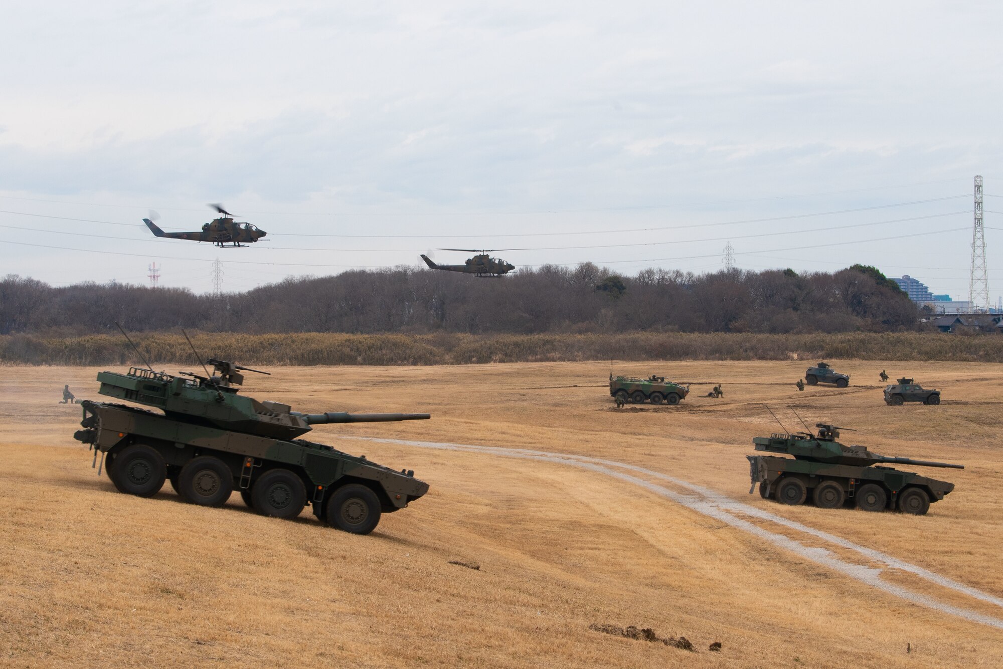 Armored vehicles and helicopters in formation