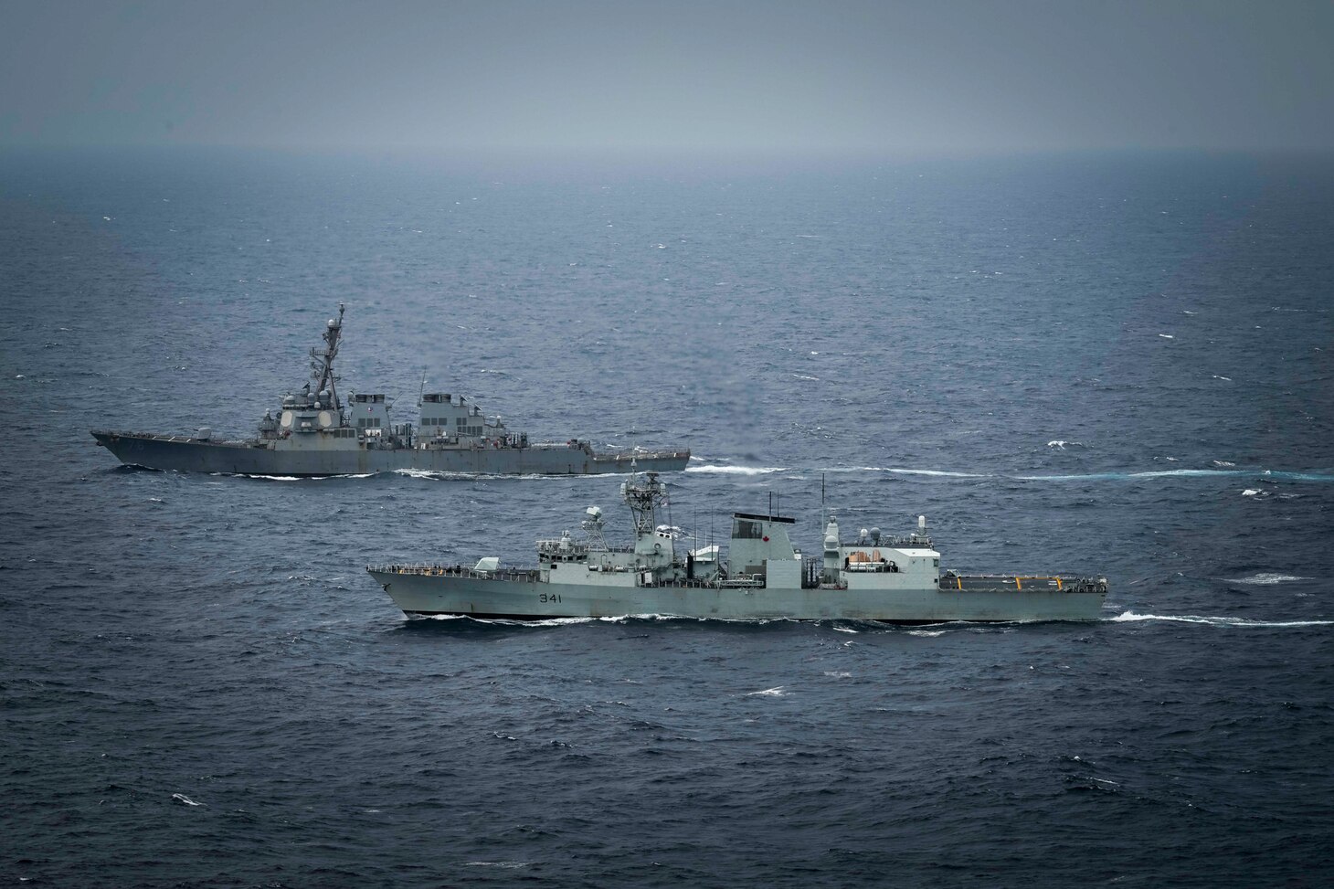 United States Ship Higgins (DDG76) and His Majesty’s Canadian Ship Ottawa conduct manoeuvers in international waters during exercise Noble Wolverine in the South China Sea on 11 January 2025. Photo Credit: Sailor 3rd Class Jacob Saunders, Canadian Armed Forces Photo.