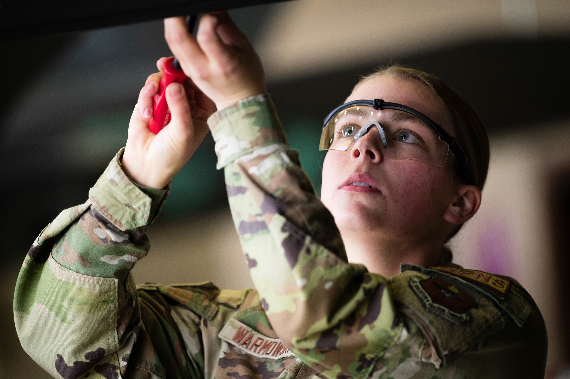 U.S. Air Force Senior Airman Preston Warmowski, 308th Aircraft Maintenance Unit maintainer, secures a bolt into an F-35 Lightning II during the First Quarter Weapons Load Competition.