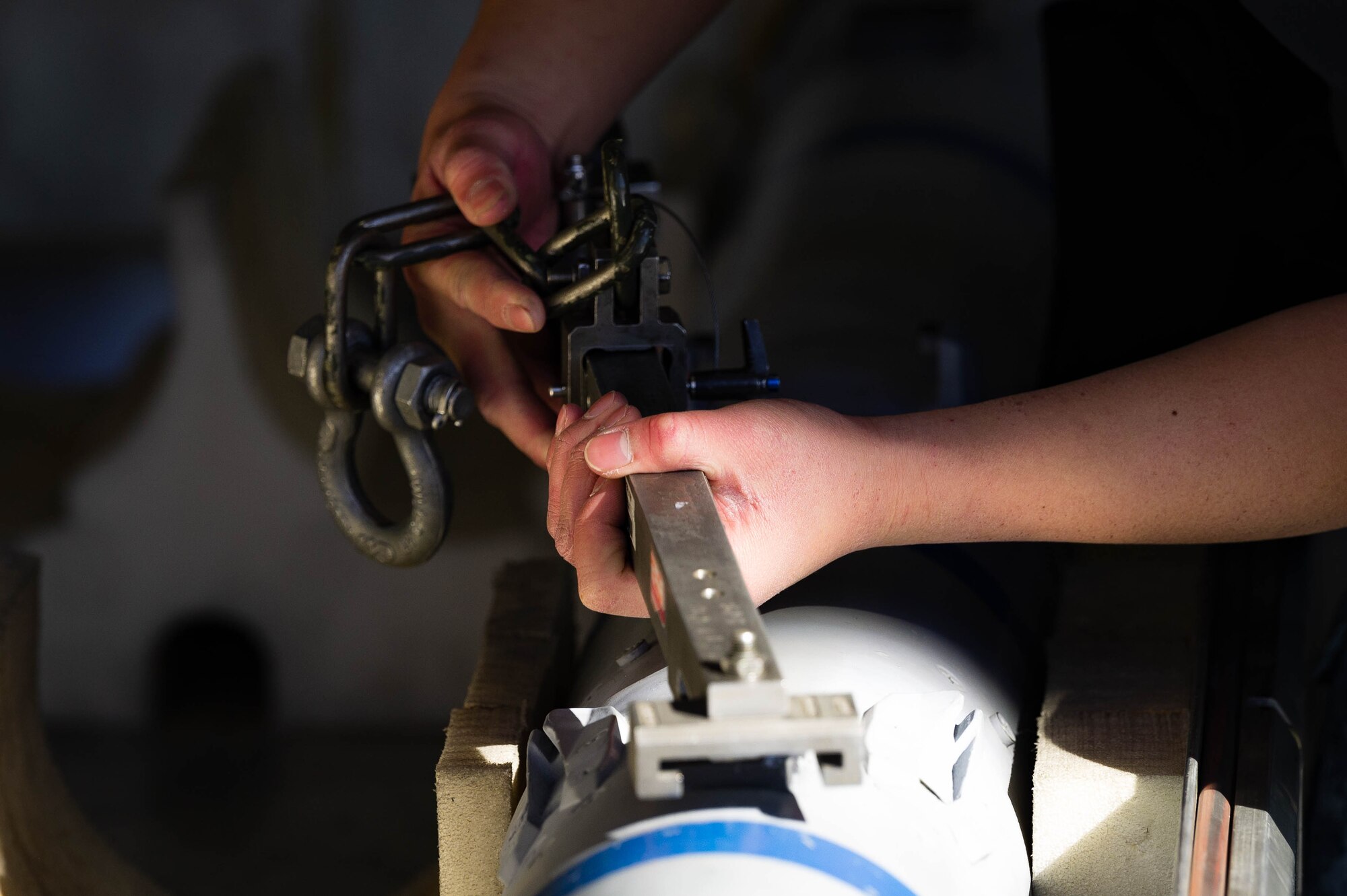 Republic of Singapore Air Force ME1-2 Rui Xiang Wong, 425th Aircraft Maintenance Unit maintainer, secures an AIM-120 AMRAAM missile during the First Quarter Weapons Load Competition.
