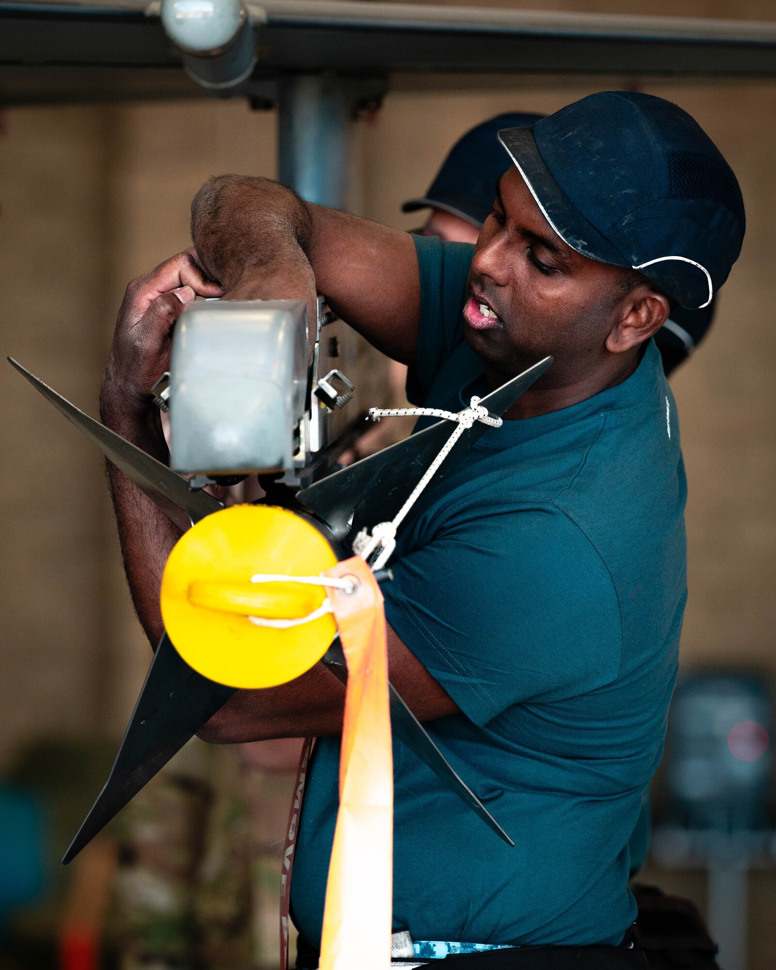 Republic of Singapore Air Force ME2-2 Yogaraj, 425th Aircraft Maintenance Unit maintainer, secures an AIM-120 AMRAAM missile during the First Quarter Weapons Load Competition.