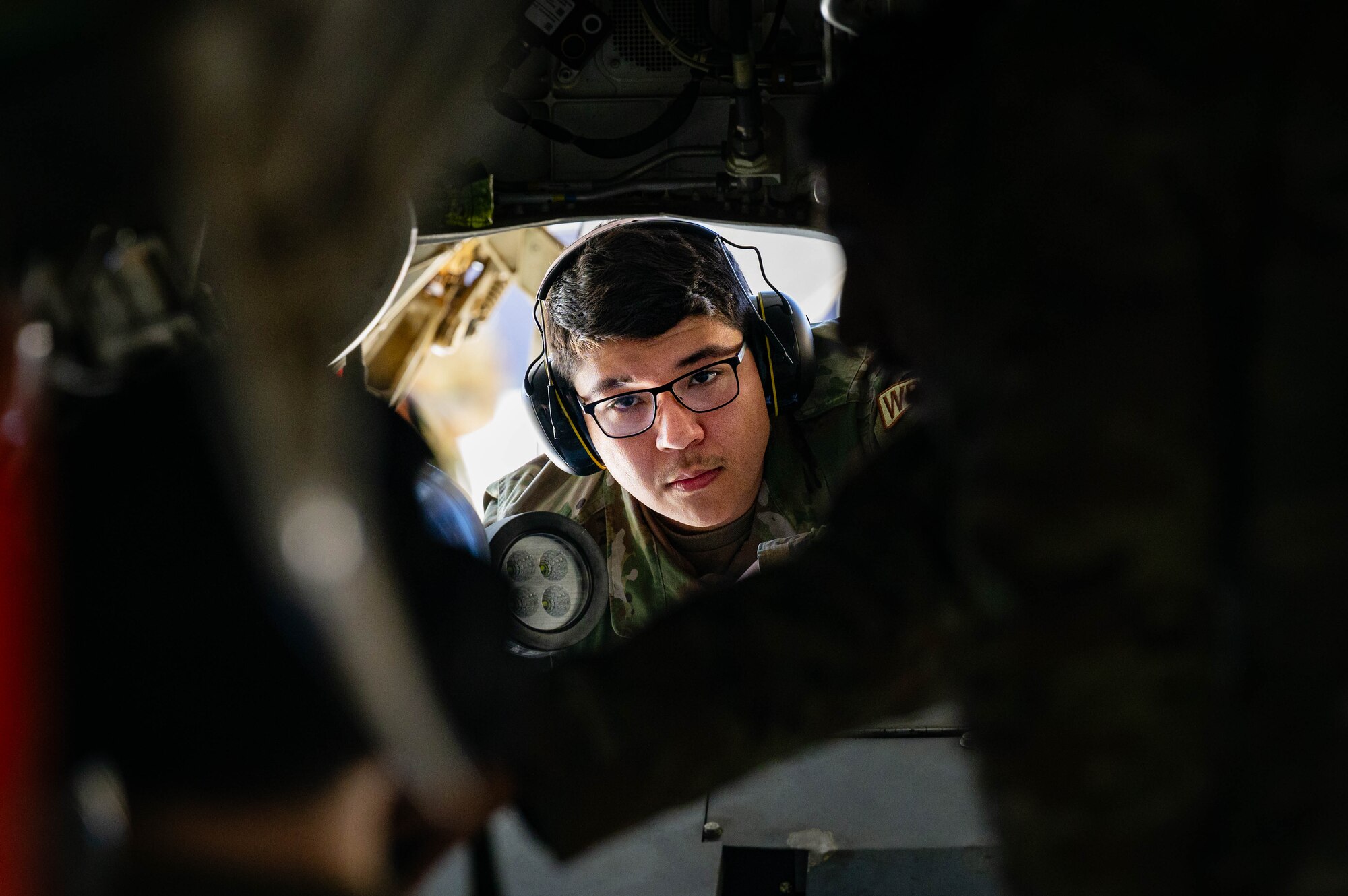 U.S. Air Force Airman 1st Class Jonathan Plancarte Sedano, 308th Aircraft Maintenance Unit maintainer, observes maintenance for a U.S. Air Force F-35 Lightning II.