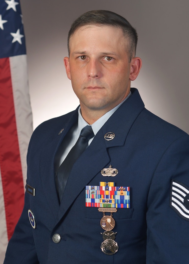Official U.S. Air Force photo with McMahon in a studio with flag behind right shoulder.