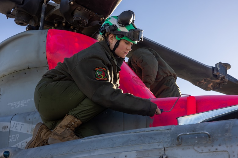 U.S. Marine Corps Cpl. Aysha Romeis, a helicopter airframe mechanic with Marine Light Attack Helicopter Squadron (HMLA) 367, Marine Aircraft Group 39, 3rd Marine Aircraft Wing, paints a UH-1Y Venom at Marine Corps Air Station Camp Pendleton, California, Jan. 10, 2025