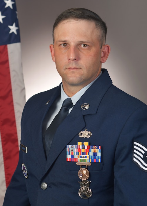 Official U.S. Air Force photo with McMahon in a studio with flag behind right shoulder.