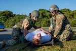 U.S. Air Force Airmen with the 18th Medical Group transfer a simulated patient onto a stretcher during a mass casualty scenario during a routine readiness exercise at Kadena Air Base, Japan, Jan. 14, 2025.