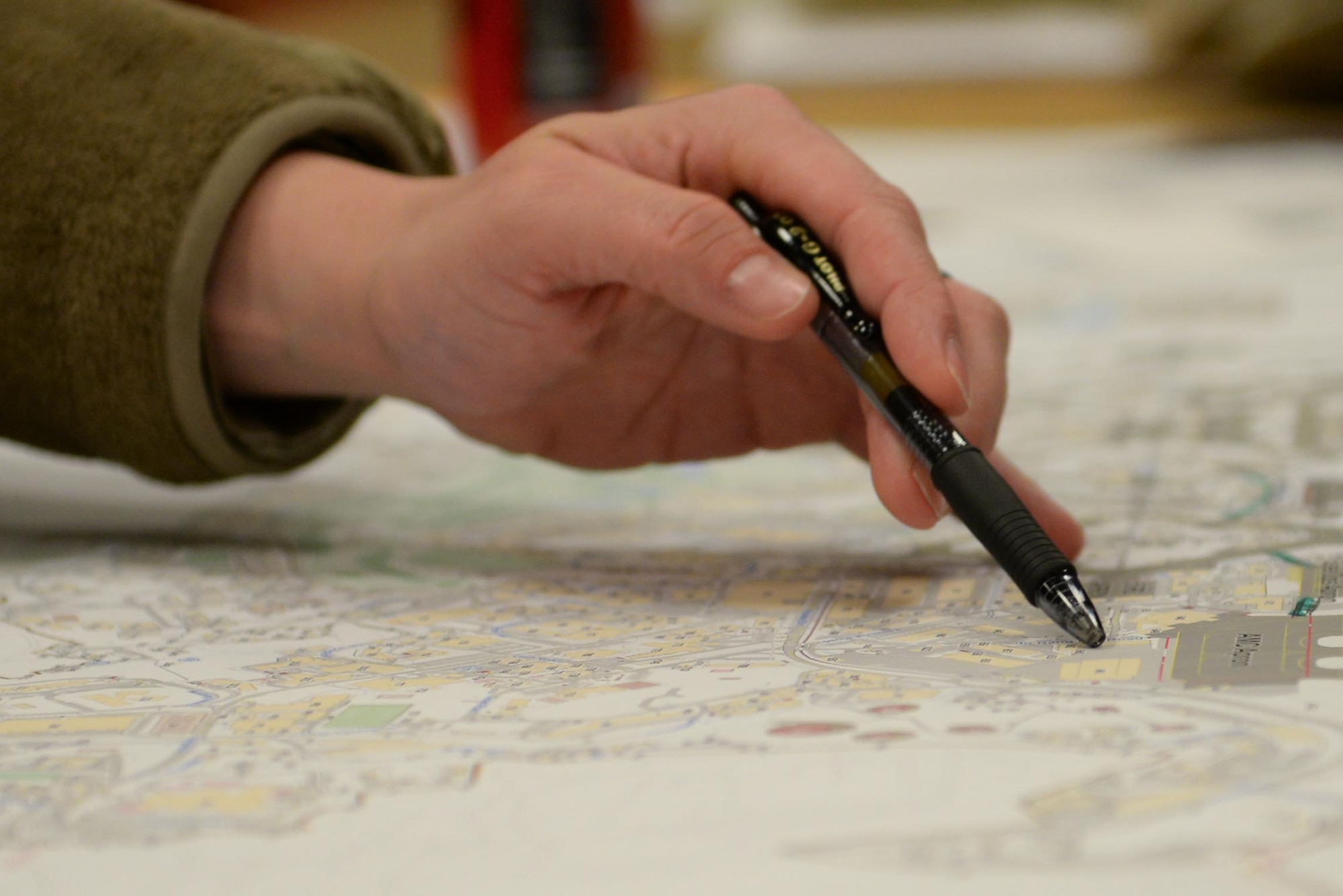 An Airman points to an installation map during the Osan Planning Charrette at Osan Air Base, Republic of Korea, Jan. 6, 2025. A planning charrette shrinks the time it takes to brainstorm, troubleshoot, deconflict, and organize ideas and inputs around what infrastructure decisions will best suit the needs of the future of a base. The goal is for this year’s planning to be fully manifested and wholly supporting the missions assigned to the 51st Fighter Wing by 2035. (U.S. Air Force photo by Staff. Sgt. Kahdija Slaughter)