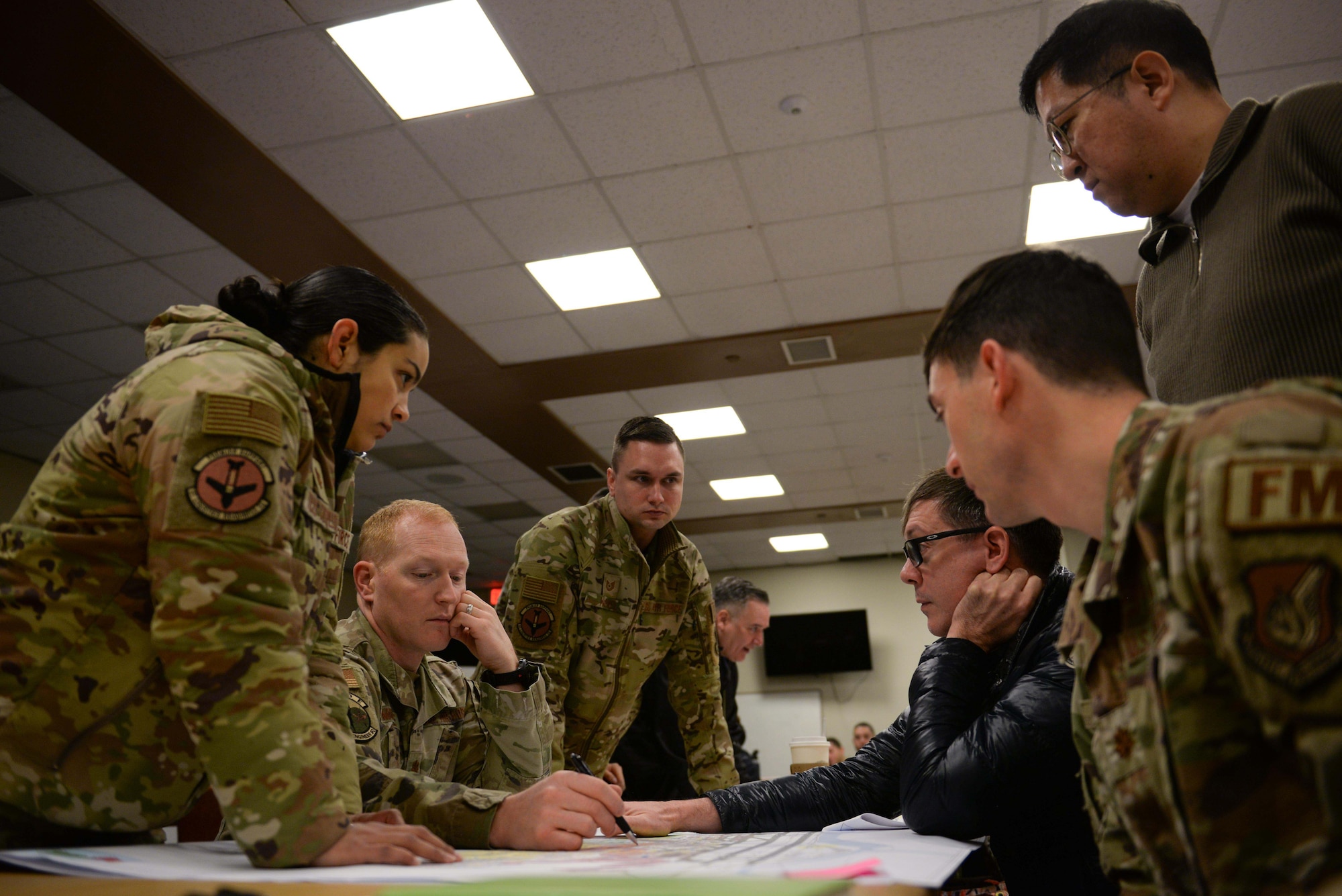 Personnel assigned to the 51st Fighter Wing brainstorm infrastructure placements during the Osan Planning Charrette at Osan Air Base, Republic of Korea, Jan. 7, 2025. The charrette allowed key military, civilian, and contractor stakeholders to brainstorm solutions to future infrastructure plans. The aggregated ideas will impact the placement of roads, buildings, and taxiways for the next 10 years. (U.S. Air Force photo by Staff. Sgt. Kahdija Slaughter)