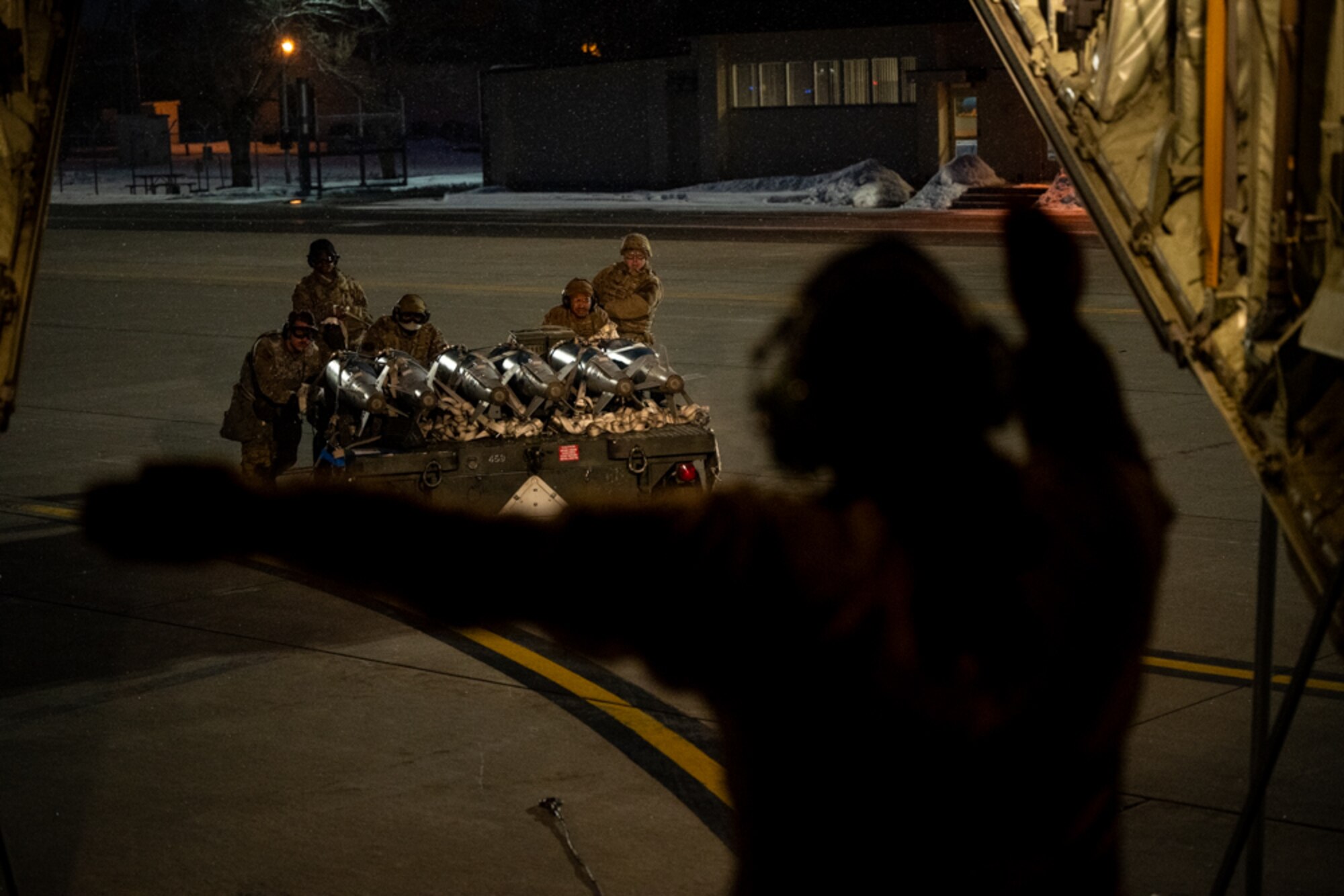 Airmen push cargo