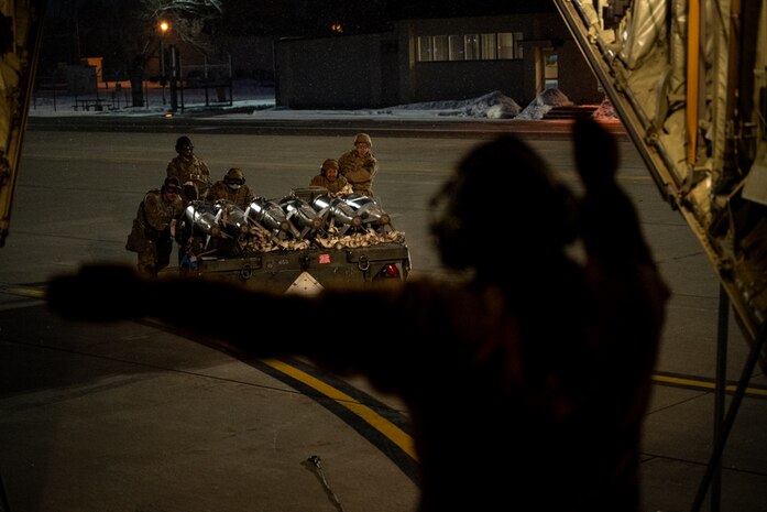 Airmen push cargo