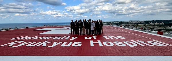 The group overlooks the city of Ginowan and the U.S. Naval hospital from the 12th floor helicopter pad.