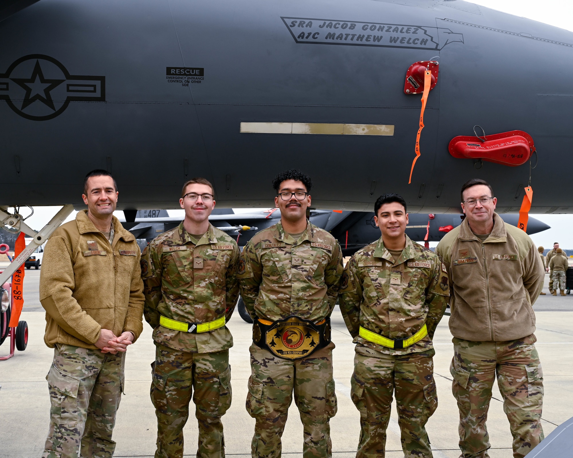 U.S. Airmen assigned to the 336th Fighter Generation Squadron pose with 4th Fighter Wing leadership for a photo after winning the Dedicated Eagle Keeper award at a quarterly load crew competition at Seymour Johnson Air Force Base, North Carolina, Jan. 10, 2025. Each quarter, load crews from each unit compete against each other in a timed competition that tests their dress and appearance, weapons knowledge and speed and accuracy of loading munitions on an F-15E Strike Eagle. (U.S. Air Force photo by Airman 1st Class Rebecca Tierney)