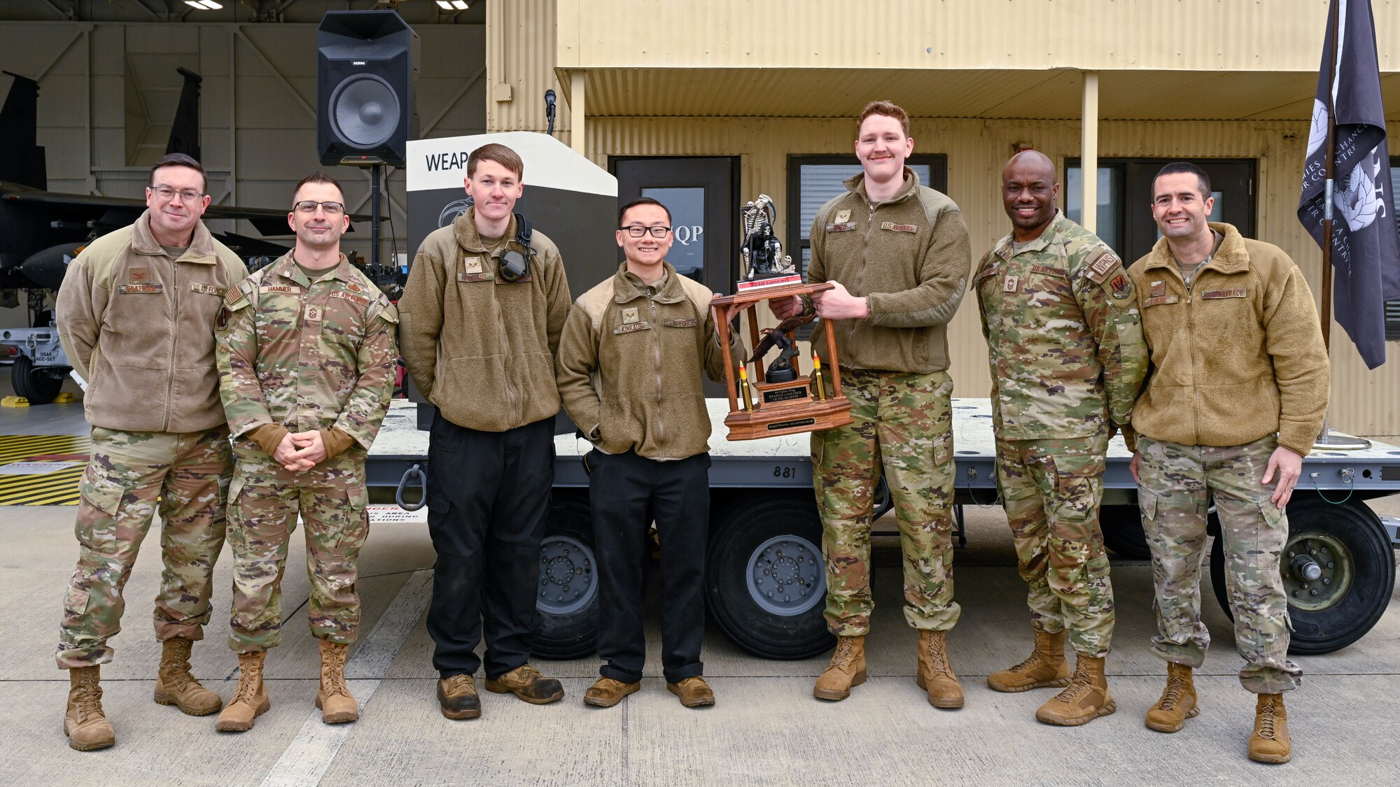 U.S. Airmen assigned to the 333rd Fighter Generation Squadron pose with 4th Fighter Wing leadership for a photo after winning 1st place at a quarterly load crew competition at Seymour Johnson Air Force Base, North Carolina, Jan. 10, 2025. The purpose of the competition is to motivate and train Airmen to quickly and efficiently load munitions on aircraft for deployments and real world operations. (U.S. Air Force photo by Airman 1st Class Rebecca Tierney)